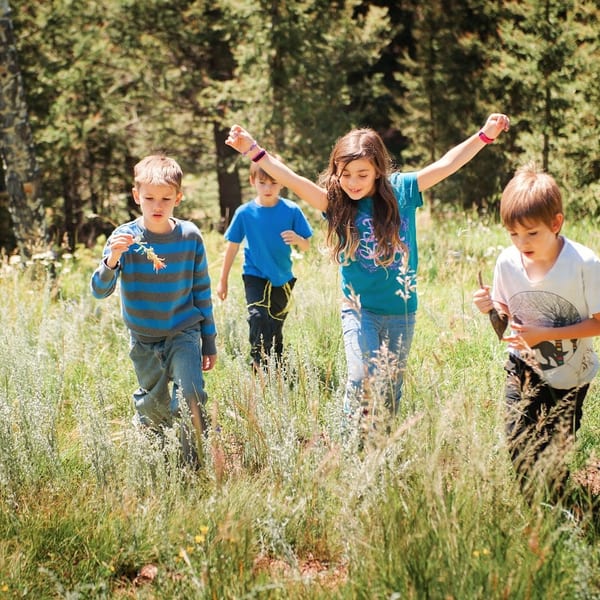 Children playing freely outdoors in nature