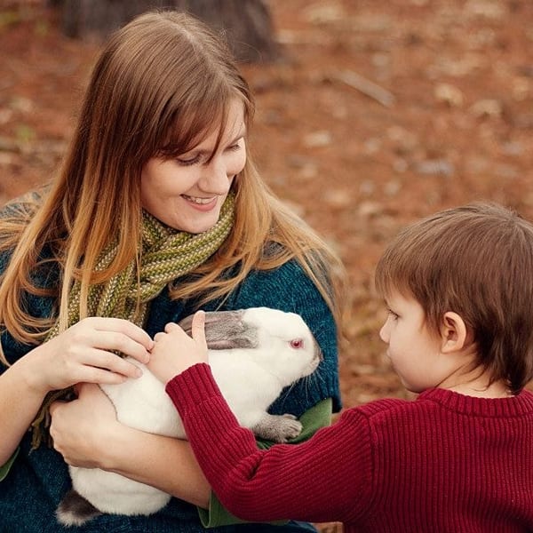 Mother babywearing in a carrier outdoors in nature