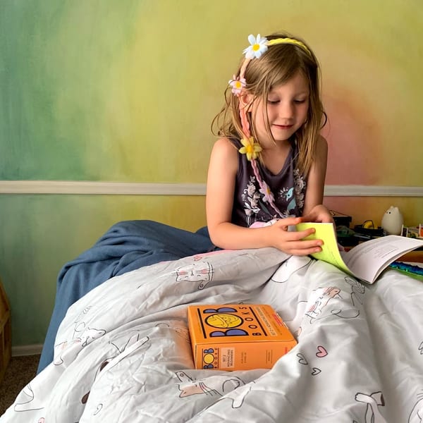 Adult reading aloud to children in a cozy setting