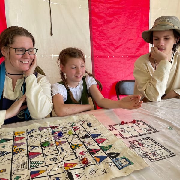 Friends gathered around a table playing a board game