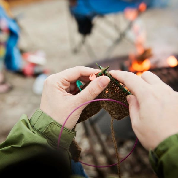 Hands knitting with warm wool yarn