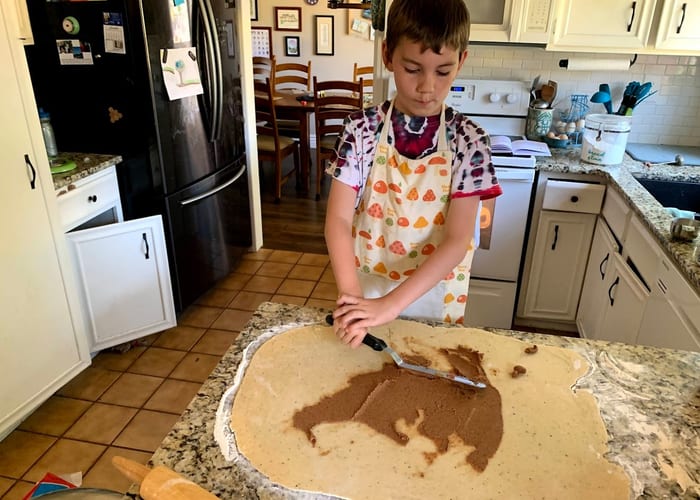 Child helping in the kitchen baking together
