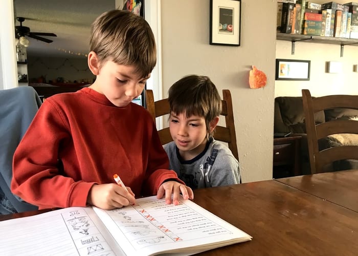 Child writing and working through math